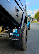 Close-up of a vehicle tire with custom Flappies' branding on a road.